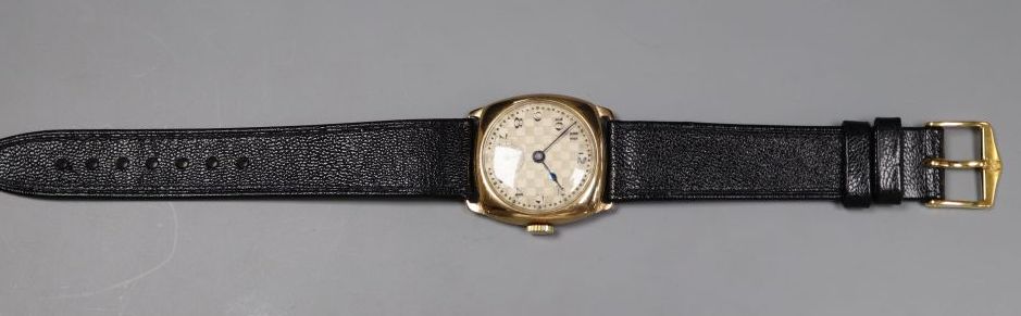 A gentlemans early 1930s 9ct gold manual wind wrist watch, with checkered dial, on later strap.